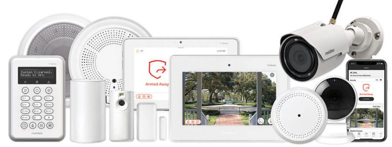 Verkada Installers A collection of home security devices, including a keypad, sensors, alarm, smart display screens showing a camera feed, a surveillance camera by Jendy Physical Security, speaker, and a smartphone with the security app displayed.