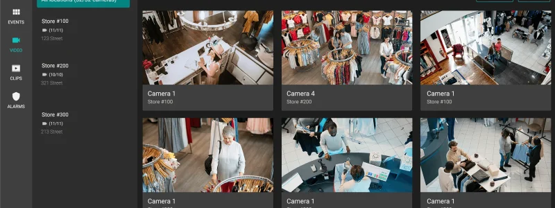 Verkada Installers A computer screen displays a Verkada Installers security camera dashboard showing live video feeds from multiple clothing stores, with a sidebar listing camera locations and navigation options for enhanced physical security.